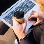 Hombre trabajando con un portátil en una mesa de café en Madrid